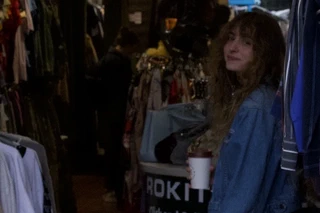 Soft portrait inside a vintage shop with a coffee cup